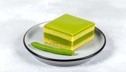 Elegant Matcha Cake Slice on a White Plate.