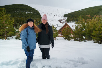 Women smiling in deep snow during winter travel