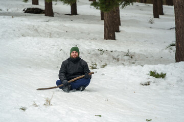 Man resting in winter forest enjoying outdoor leisure time