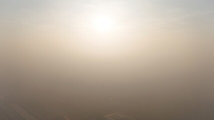 Sunlight Through Morning Fog in Calm Natural Sky
