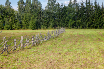 Rustic Wooden Stake Fence on Pasture