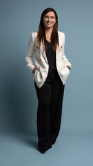 Beautiful, attractive, middle aged woman wearing casual white jacket standing isolated on blue background