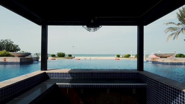 infinity swimming pool in tropical resort with pool side beach bar, luxury travel and holidays concept stock video in 4k res 