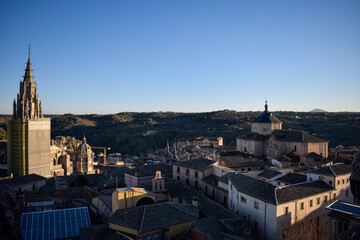 Obraz premium Historic Rooftops and Church Towers at Sunset in Toledo, Spain