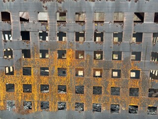 The rusted metal paneling of a well-used outdoor fire pit