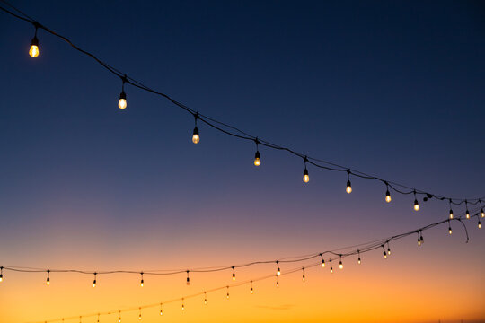 Outdoor string lights with twilighy sky background