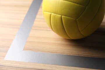 One volleyball ball on floor, closeup. Space for text