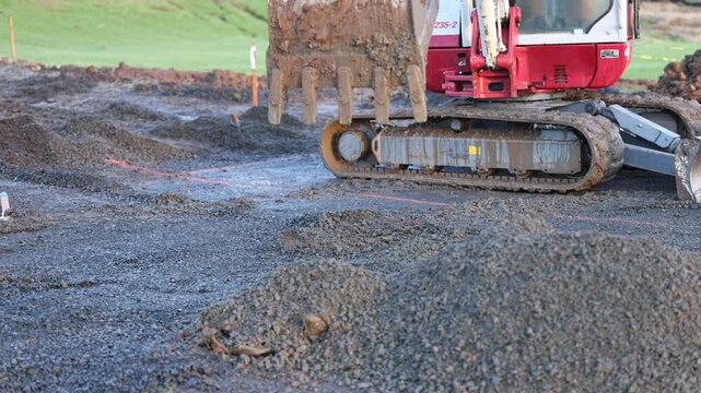 Tractor dumping gravel fill materials