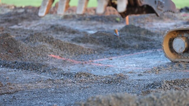 Excavator dumping gravel