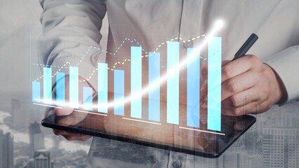A business professional reviews market growth data on a tablet, showcasing modern graphs and charts that represent success, progress, and strategic planning in finance. Copula
