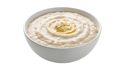 A bowl of creamy porridge with oil and almonds on top on transparent background