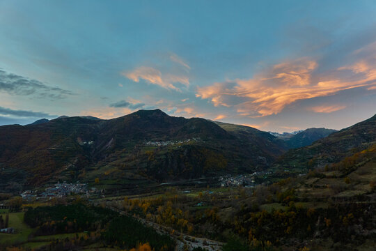 Autumn sunset over Chistau Valley with fall foliage and mountain peaks seen from La Riba viewpoint in the Pyrenees Spain