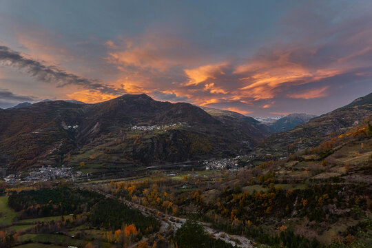 Autumn sunset over Chistau Valley with fall foliage and mountain peaks seen from La Riba viewpoint in the Pyrenees Spain