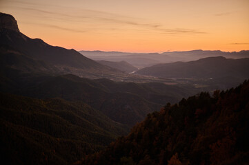 Fototapeta premium Golden hour sunset views over autumn forests and mountains along the Hermitages route in Tella Pyrenees Spain