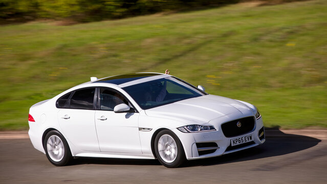 Milton Keynes,Bucks,UK - Sept. 22nd 2025:  2015 white Jaguar xf diesel engine car driving on a British road