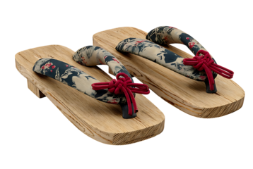 A pair of traditional japanese wooden geta sandals with floral fabric straps and red thongs isolated on transparent background