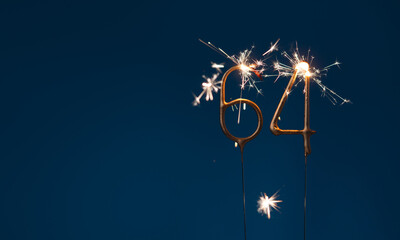 64 years celebration festive background with copy space made with Bengal fires in the form of number Sixty four.