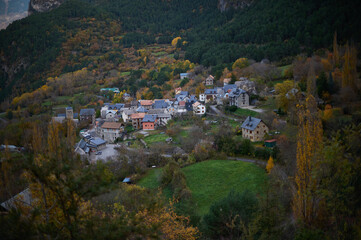 Fototapeta premium Scenic aerial view of Saravillo village in autumn surrounded by colorful Pyrenees mountains in Huesca Aragon Spain
