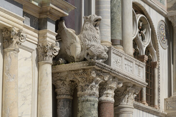 Detail of ornate capitals on marble columns at the facade of San Marco Basilica, Venice, Italy.