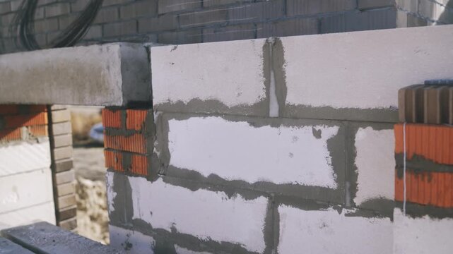 Construction site showing new residential building progress. Walls are going up using aerated concrete blocks and cement mortar
