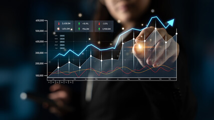 A business professional examines financial data on a digital display, highlighting growth charts and key performance indicators in a modern office environment. Scalp