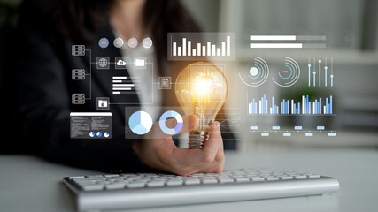A professional concept image illustrating innovation with a light bulb, digital data displays, and modern technology, symbolizing creativity and business growth in an office environment. Gantry