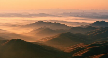 Majestic mountain landscape at sunrise with misty valleys and golden light
