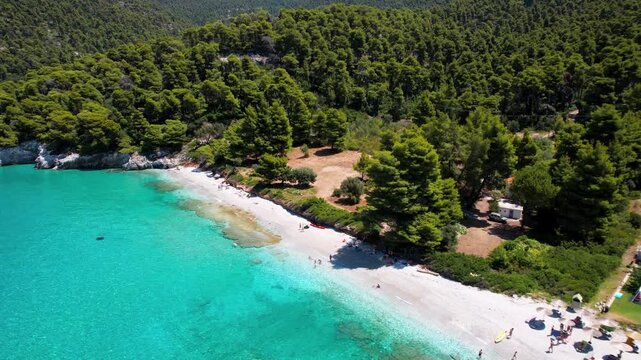 Aerial 4K Panoramic View of Milia Beach and Granite rocks with Crystal Turquoise Water and Pine Forest in Skopelos Greece