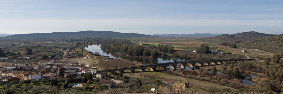 Landscape view of the ancient historic Roman bridge over the Guadiana river in Medellin Spain, a Spanish municipality in the province of Badajoz, in the autonomous community of Extremadura Spain.