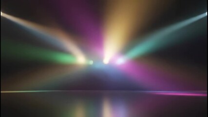 Vibrant multicolored stage spotlights illuminate an empty dark concert venue floor with atmospheric haze effects