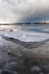 close-up of frozen ice sheet with ice crystal on the shore of Lake Constance in winter