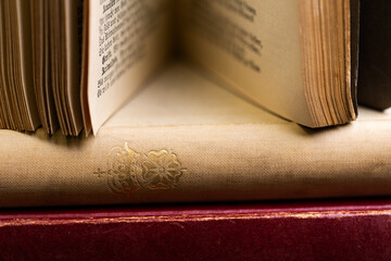 A close-up shot of an open antique book with gold embossed detailing on its cover. © JFW Photography Inc
