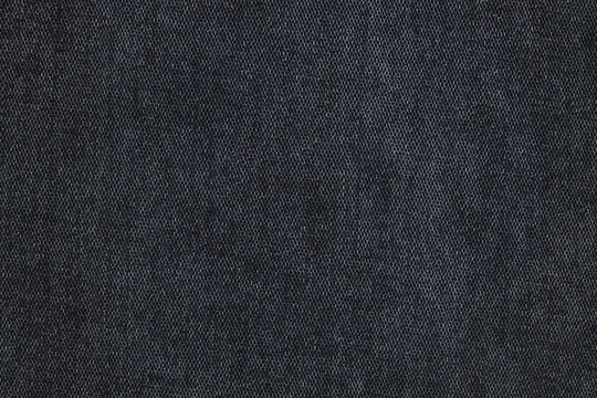 Close up of black jeans fabric texture background.