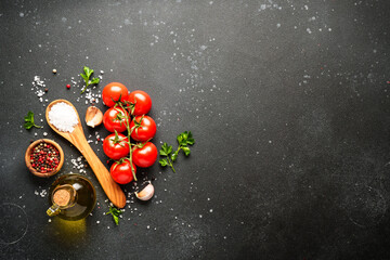 Food background with fresh vegetables, herbs and spices on black. © nadianb