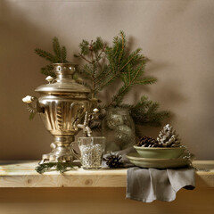 Winter New Year's still life with a samovar, a spruce branch, New Year's toys, and pine cones