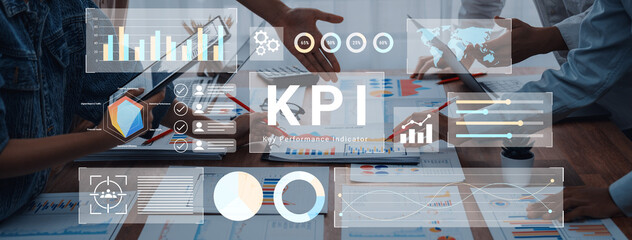 A business team engages in a collaborative meeting focused on Key Performance Indicators. They analyze graphs and charts to enhance performance and drive success. Gantry