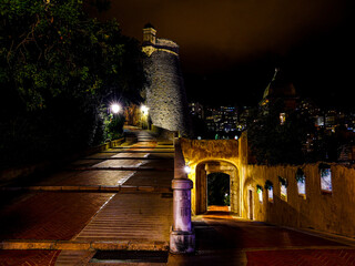 View of the 15th-century Gateway and fortifications to Le Rocher at night