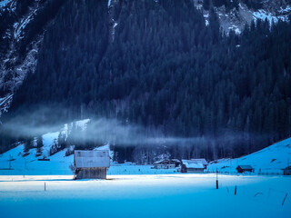 Low hanging cloud over barn at the foot of Schluchhorn, Gsteig