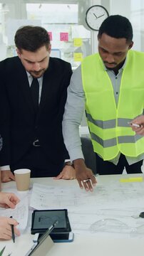 Building industry concept where likable in good mood purposeful hardworking building conctactors have meeting with smart cvalified bearded manager about building project,slow motion