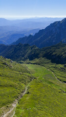 Fototapeta premium Mountain ridge, green peak, and rocky slope aerial view