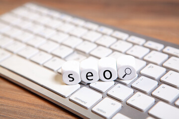 word seo on cubes on a computer keyboard. business concept.