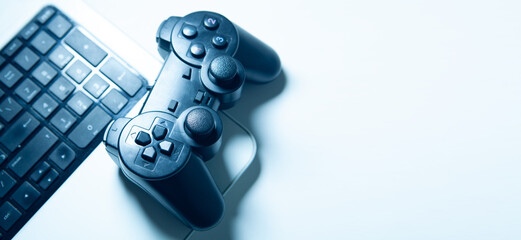 video game controller and keyboard on a white background. toning. selective focus