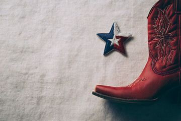 texas independence celebration, texan independence composition with lone star patch, flag pin, and cowboy boot ornament on a red and blue background with white space for text