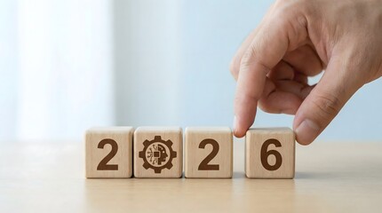 hand changing 2022 to 2026 on wooden cubes