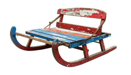 Colorful vintage sled, weathered wooden planks, red and blue paint, isolated on black background