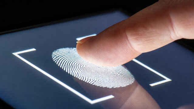 Close-up of a human finger scanning a fingerprint on a high-tech glowing digital screen, representing biometric security, identity verification, and data access - Powered by Adobe