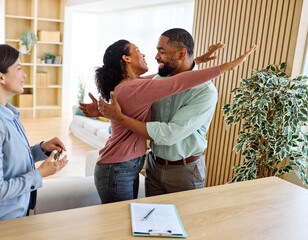 Portrait of a young happy couple celebrating a purchase of new property in agent's office