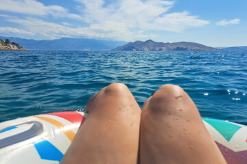 Relaxing on inflatable in serene sea with mountain views