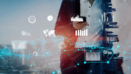 A professional businessman in a suit engages with a smartphone surrounded by digital financial data, illustrating modern analysis and decision-making in a dynamic urban setting. Xenic