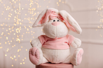 Cute plush bunny toy with soft lights background